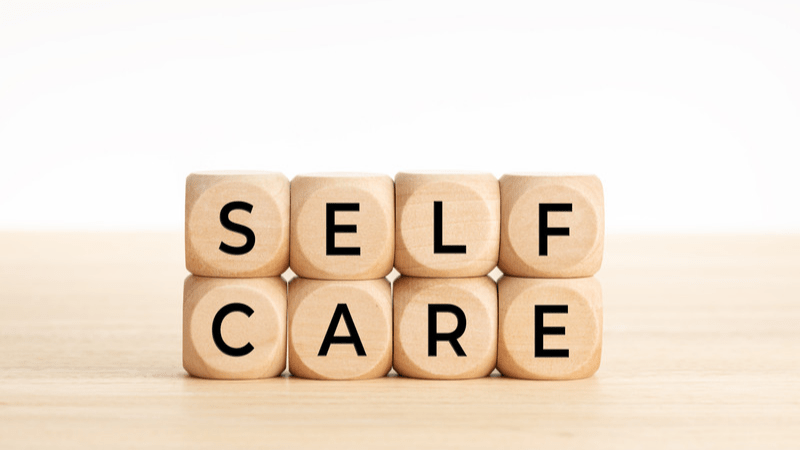 The word self-care written on a piece of paper