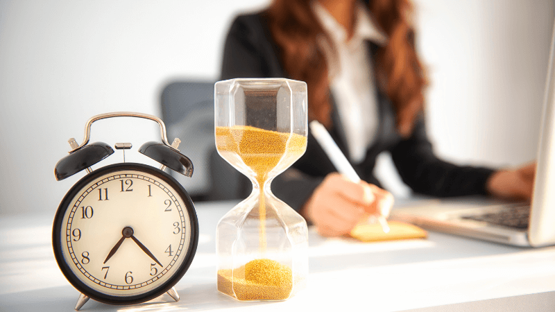 An alarm clock on top of a home office desk