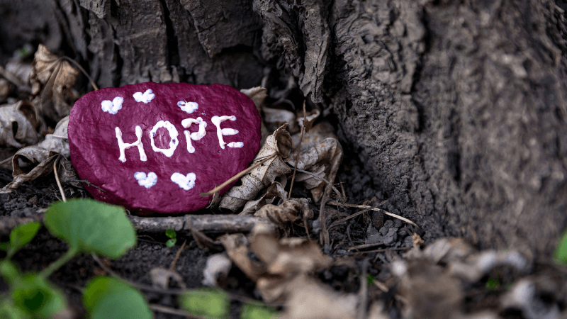 The word hope painted on a stone