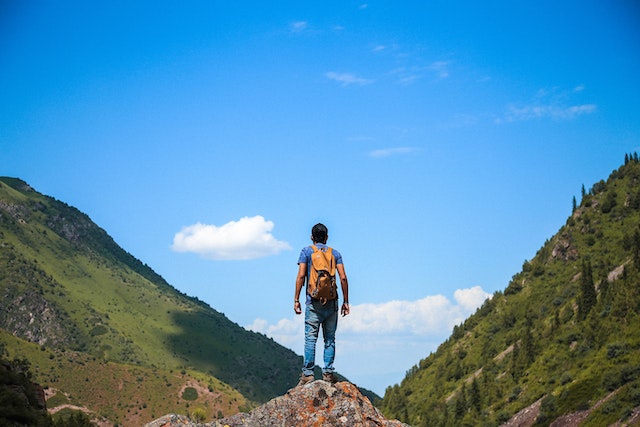 A man standing on a mountain summit
