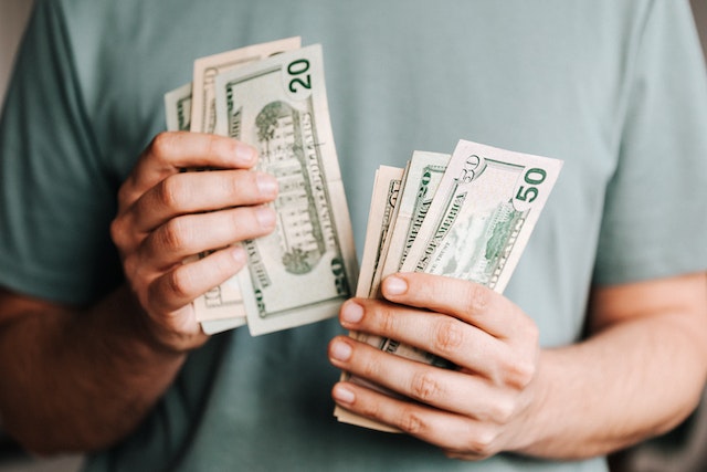 Man counting dollar bills