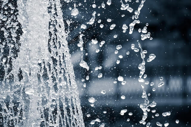 A woman splashing water on her face