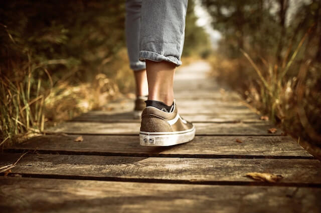 A woman taking a walk through a secluded path