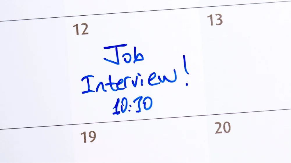 The words job interview at 10:30 written on a calendar date