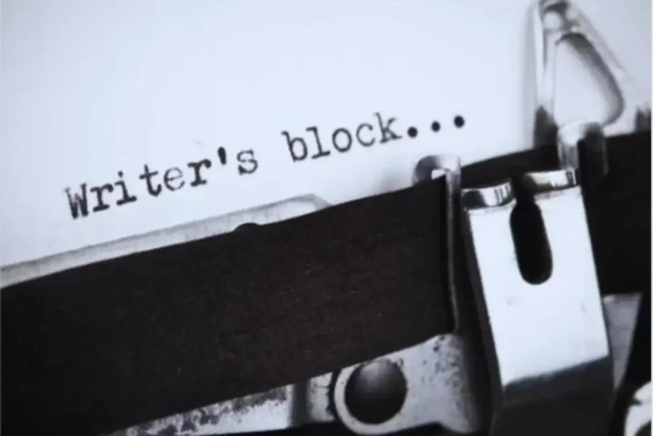 The words writer's block written by a typewriter keyboard on a white piece of paper