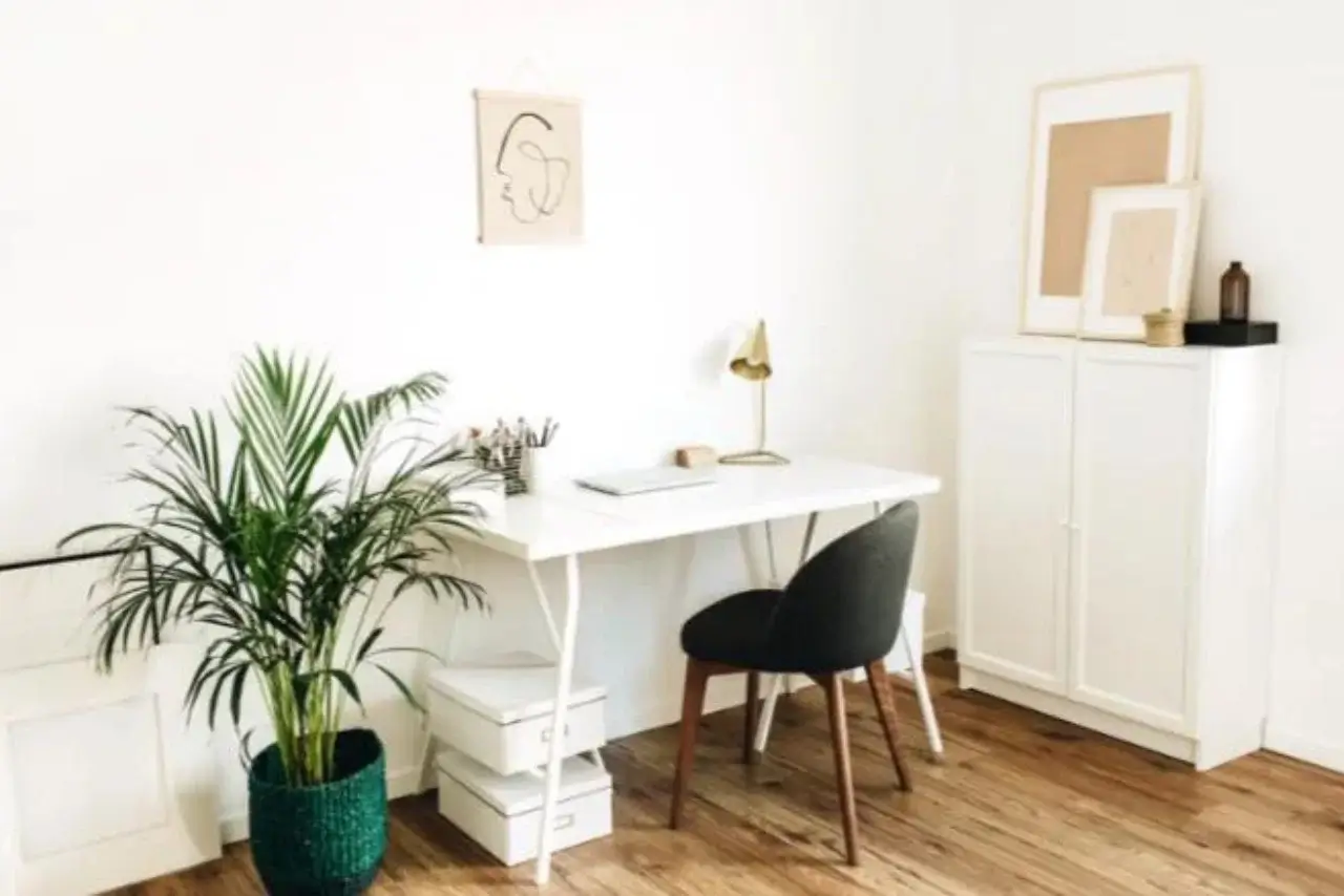 Productive home office setup with a well-organized desk, laptop, and a cup of coffee