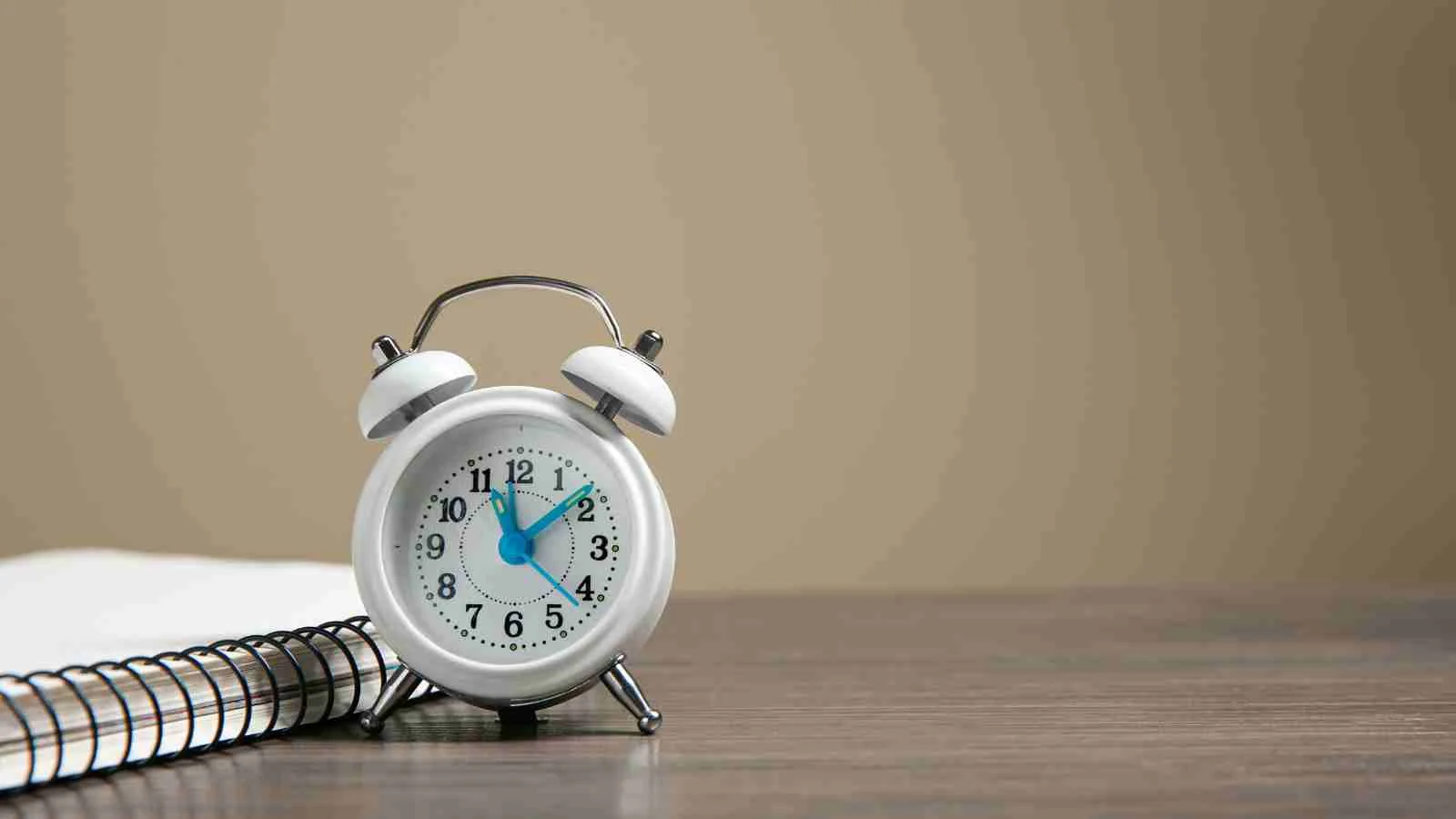 Clock and calendar representing contrasting approaches to punctuality in Canadian and American business settings.