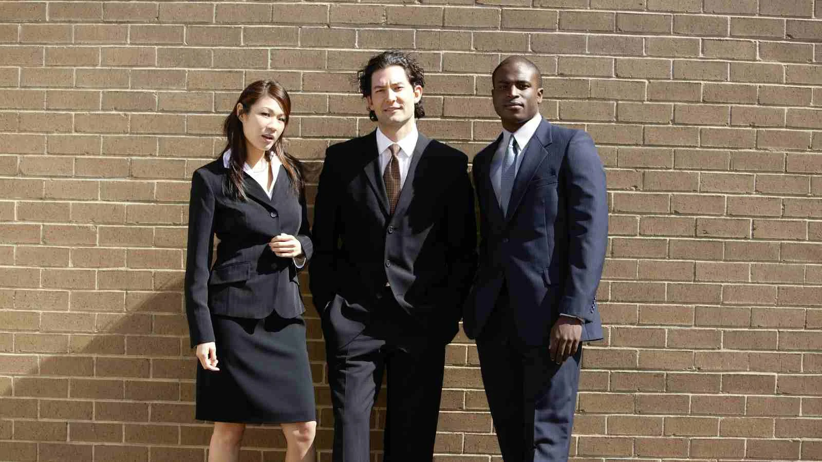 Comparison of business attire, with one side showcasing casual Canadian dress and the other formal American attire.