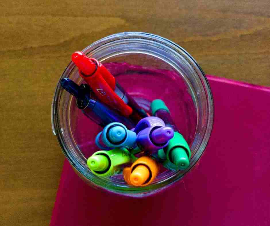 Pens and pencils inside of a mason jar