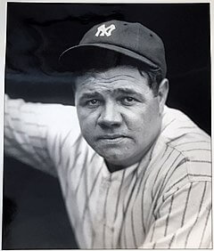 Babe Ruth sitting in the Yankee dugout during a baseball game