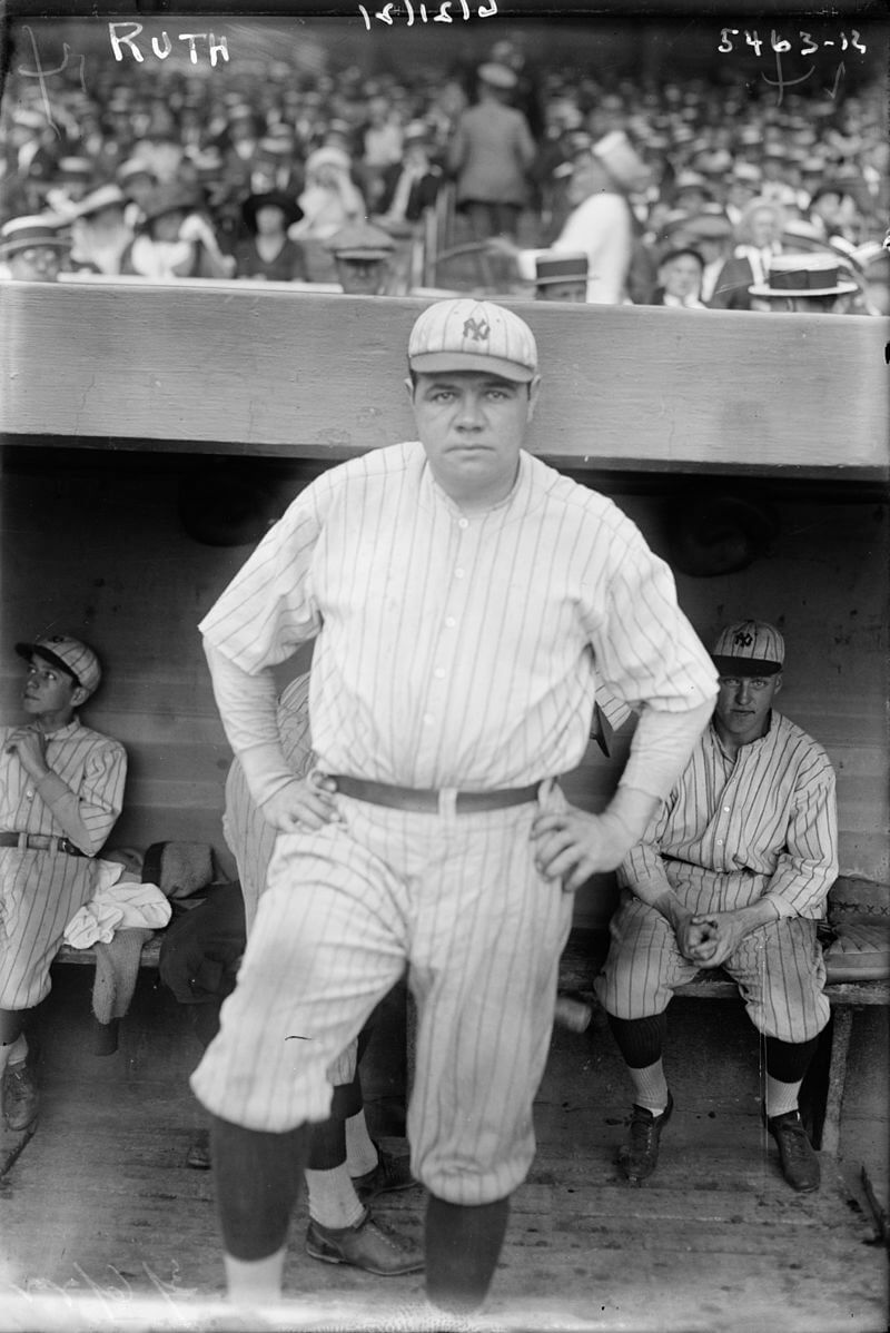 Babe Ruth standing in the Yankee dugout during a game