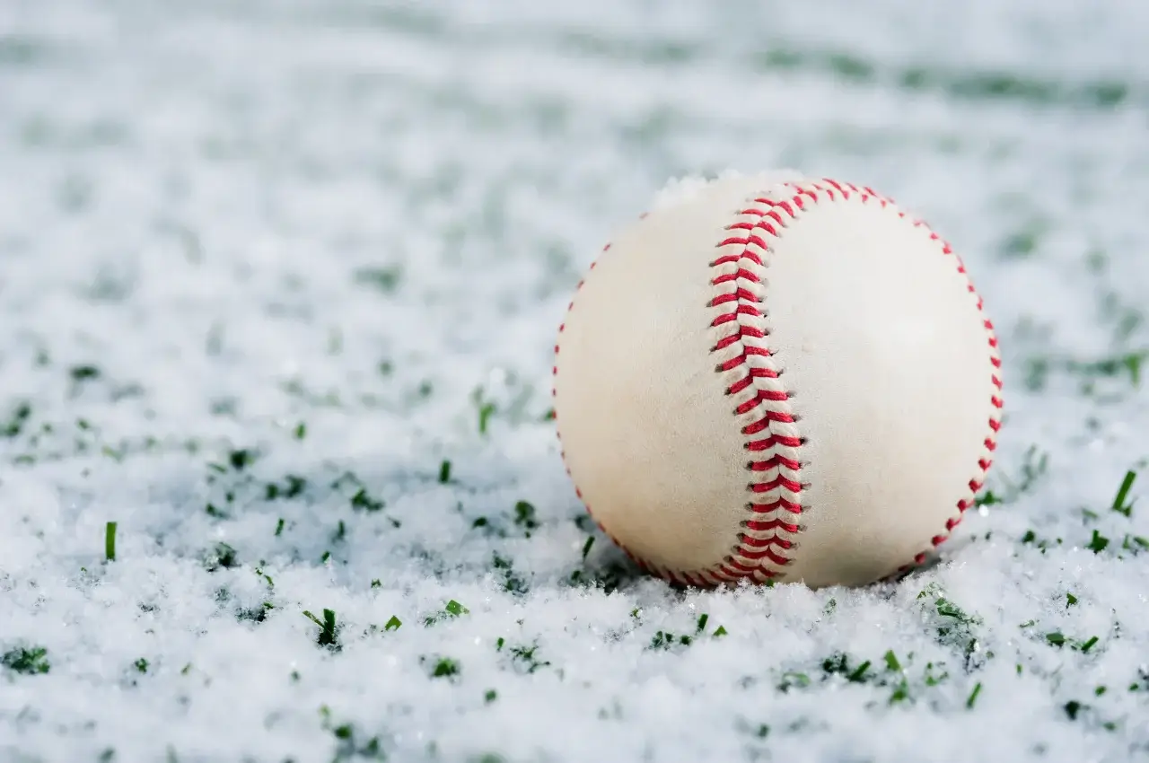 A major league baseball field covered in snow during a game