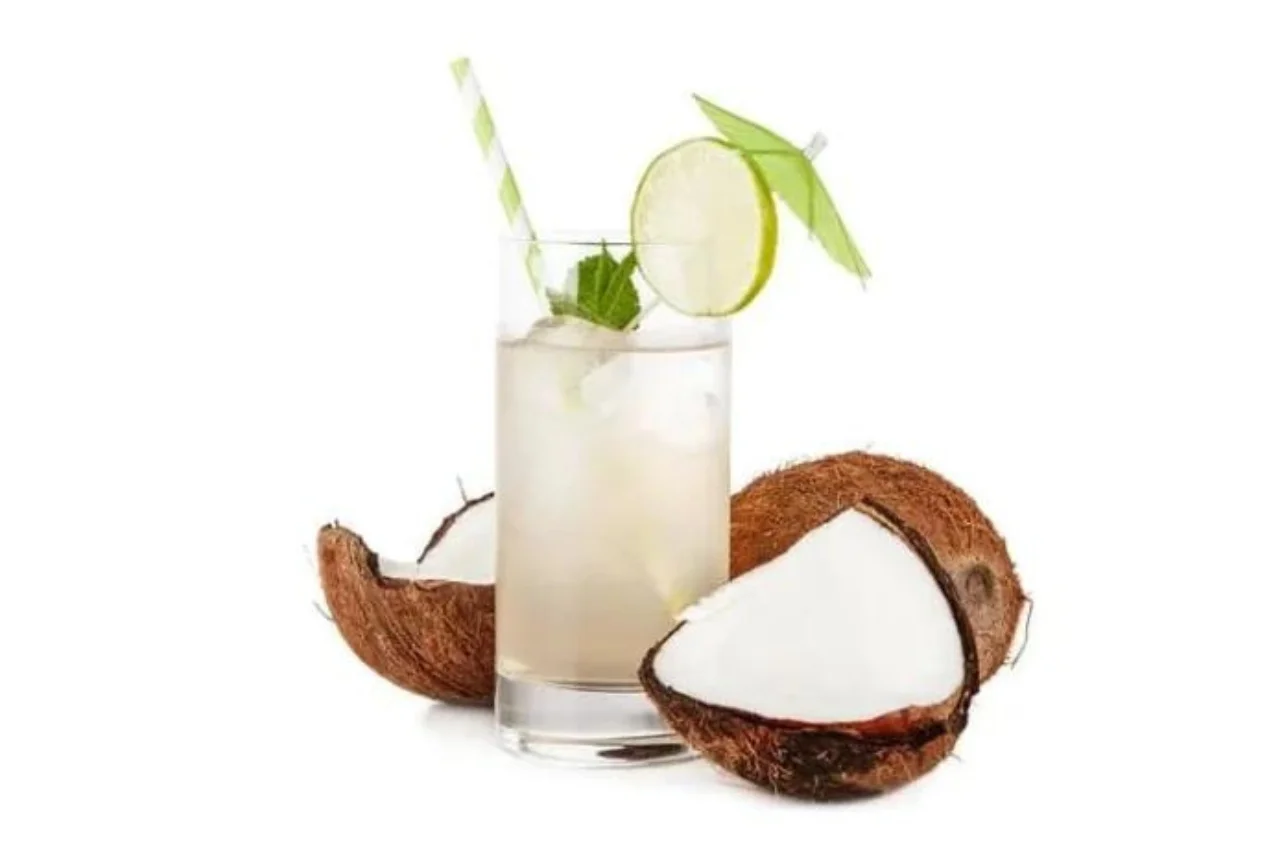 A tall glass of coconut water on a kitchen table