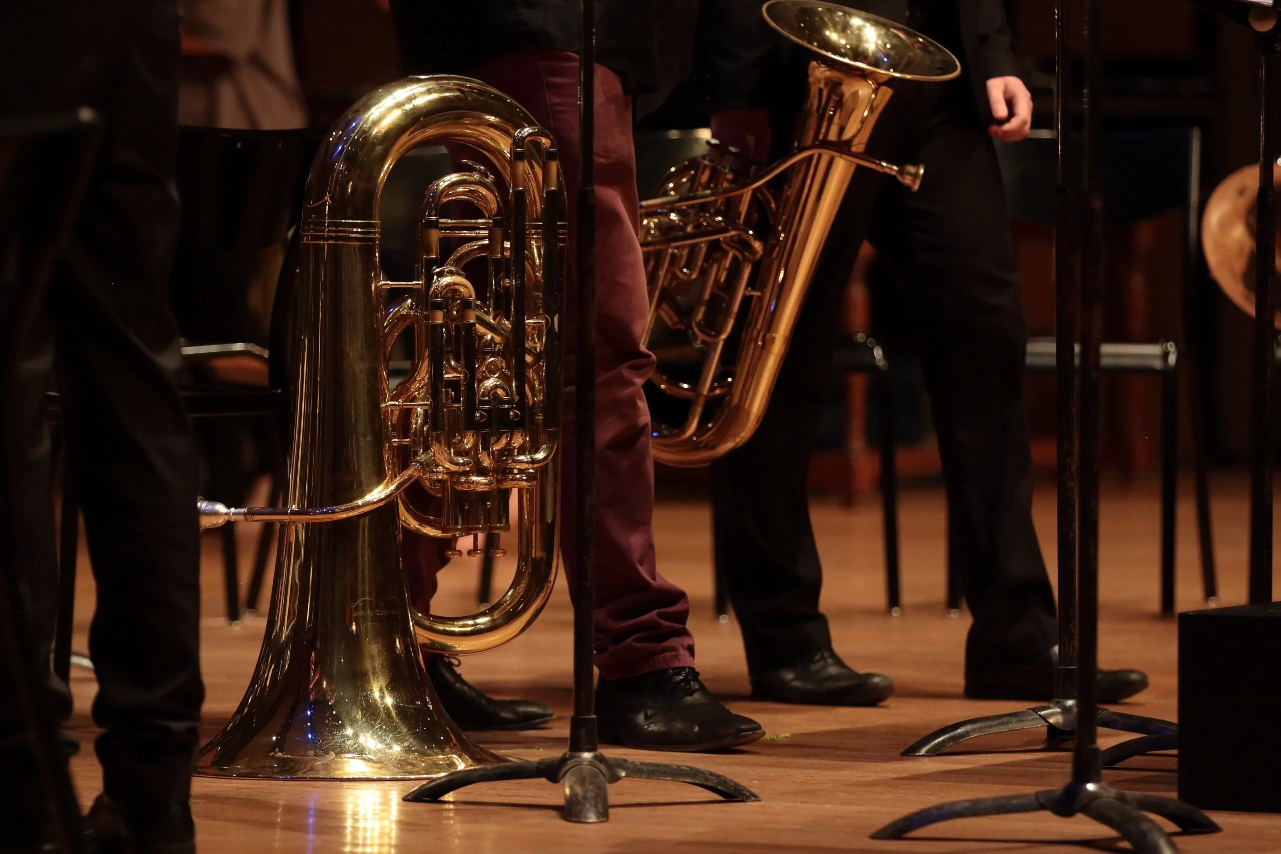 A Trombone instrument being played at a concert hall