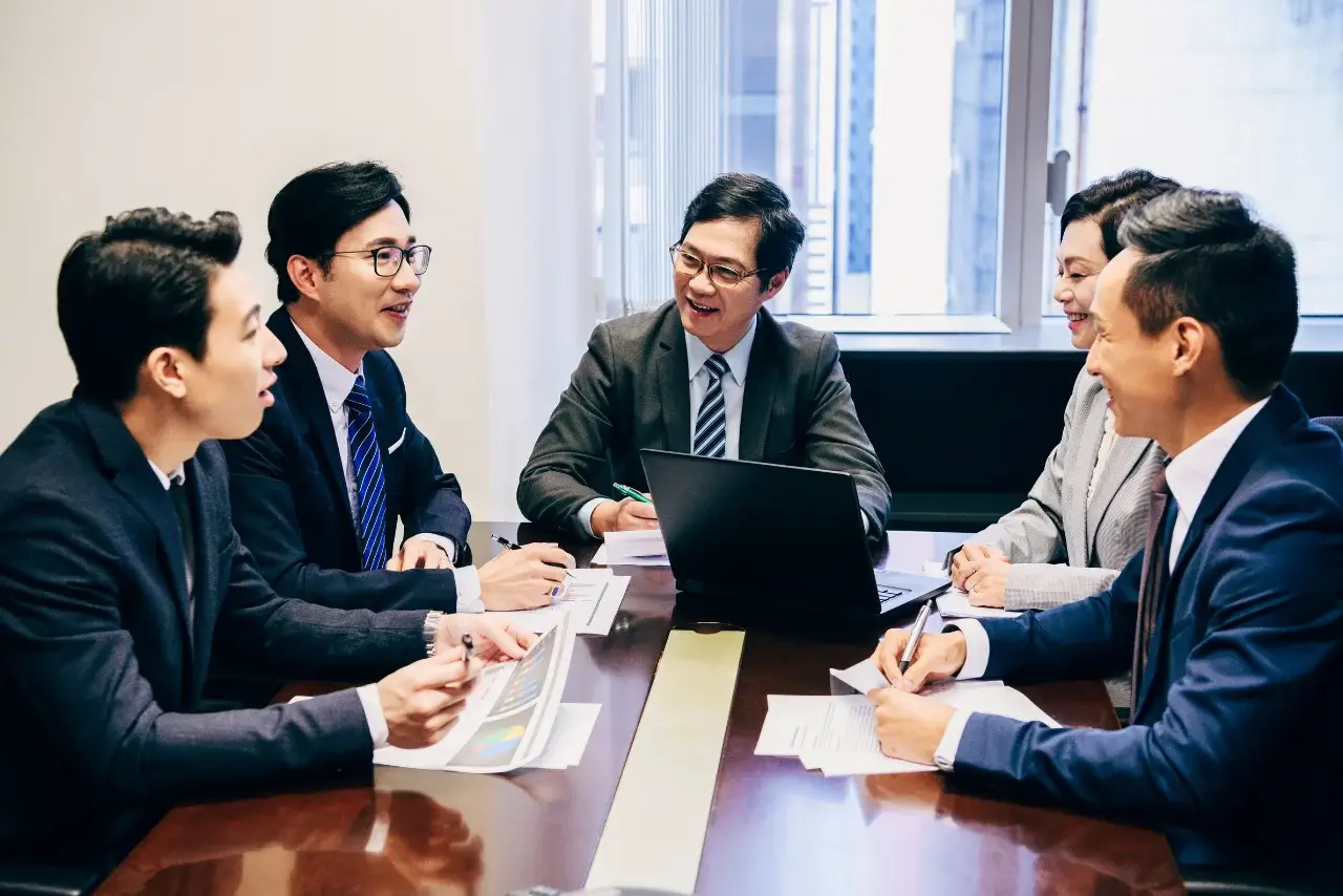 A group of Chinese businessmen meeting