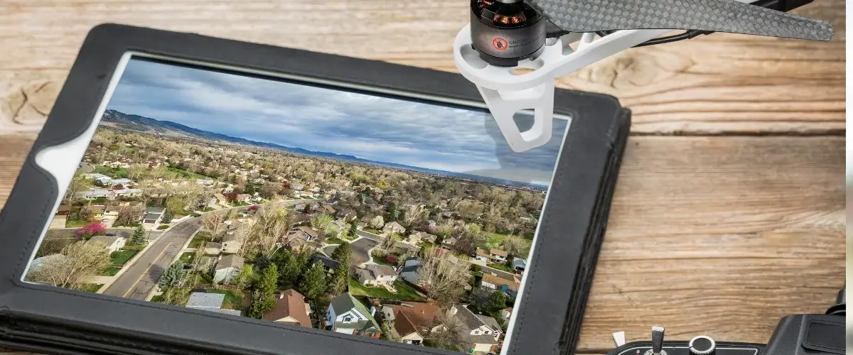 A high-tech drone surveying a large industrial complex for security purposes.