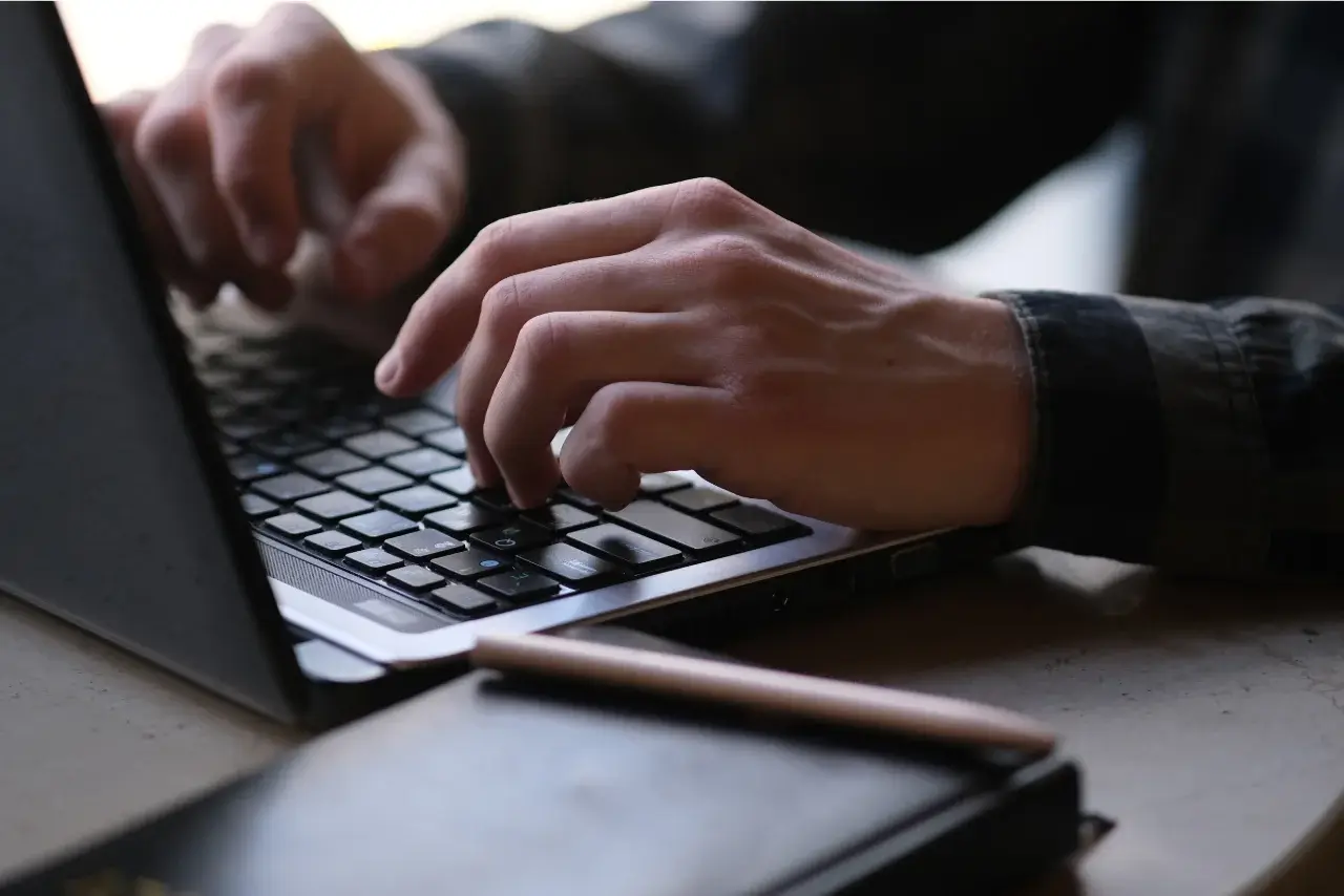 Person sitting with a laptop open taking a course