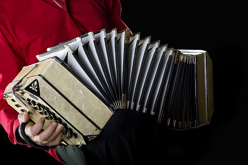 A man playing music on his Bandoneon instrument