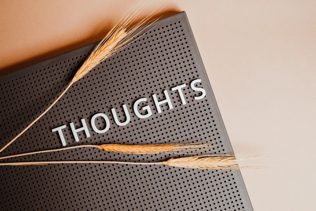 A woman sitting at a library deep in thought