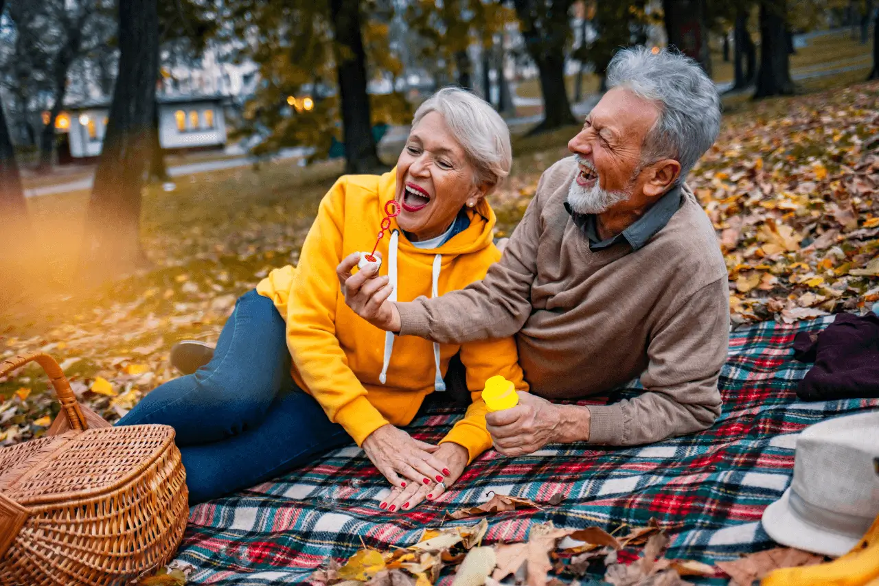 An elderly couple having a romantic picnic
