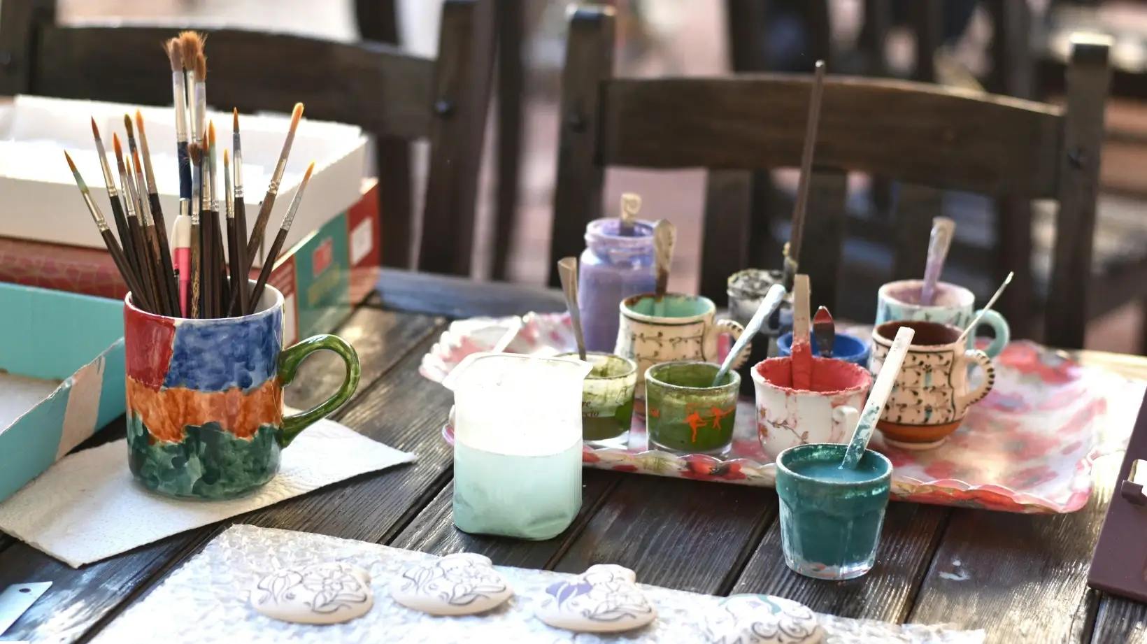 A man painting a nature scene on a canvas