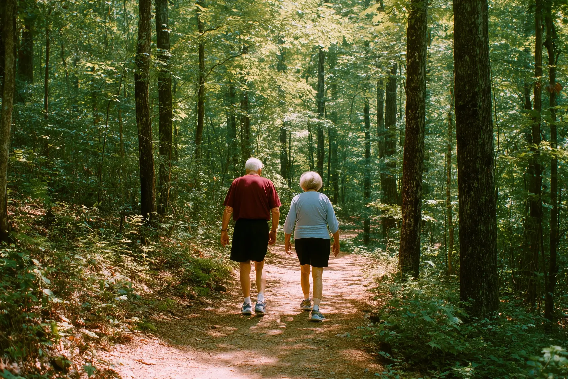 A smiling couple hiking through a forest