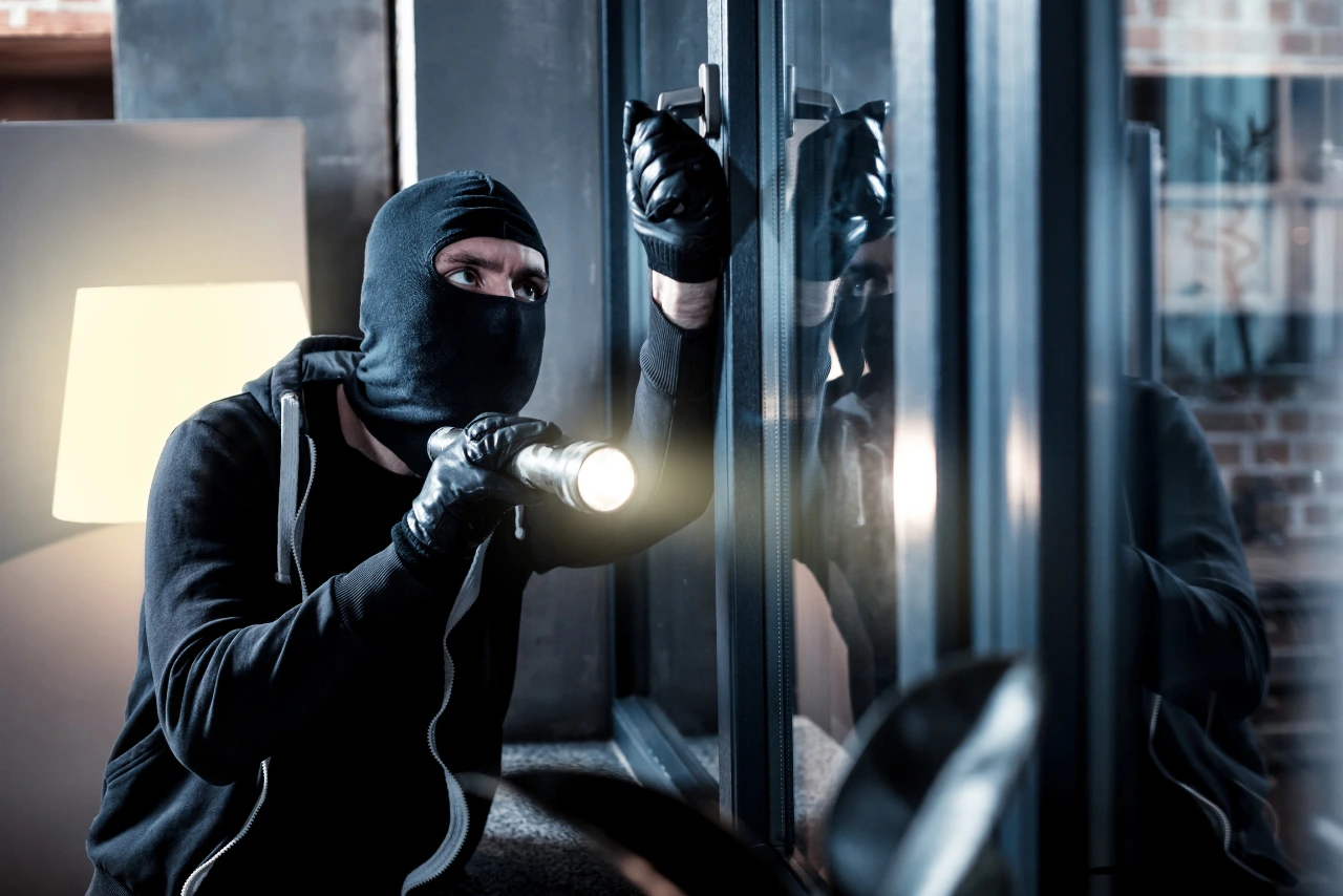 A robber outside of a place of business at night
