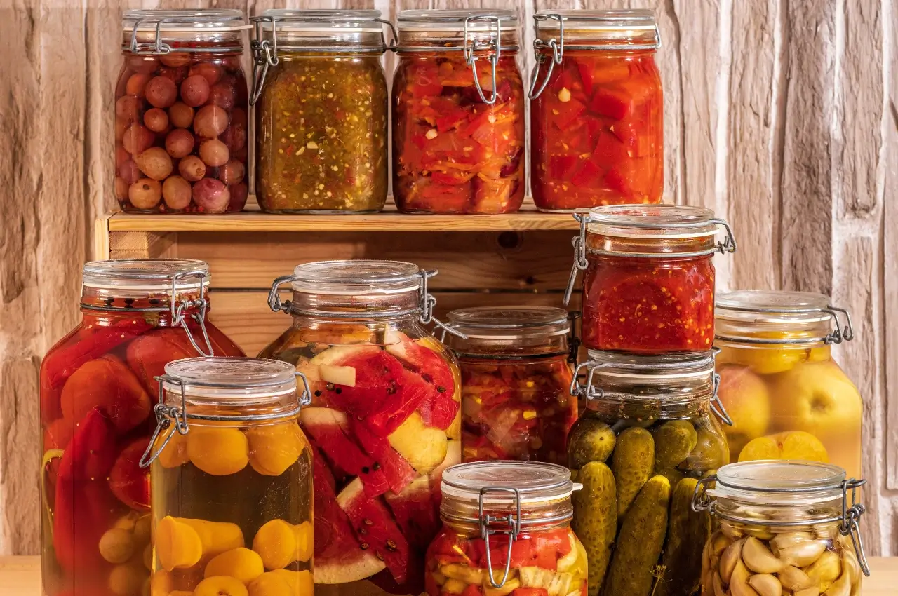 Assortment of global pickle varieties including fermented cucumbers, Korean kimchi, Indian achar, and European pickled vegetables displayed in jars