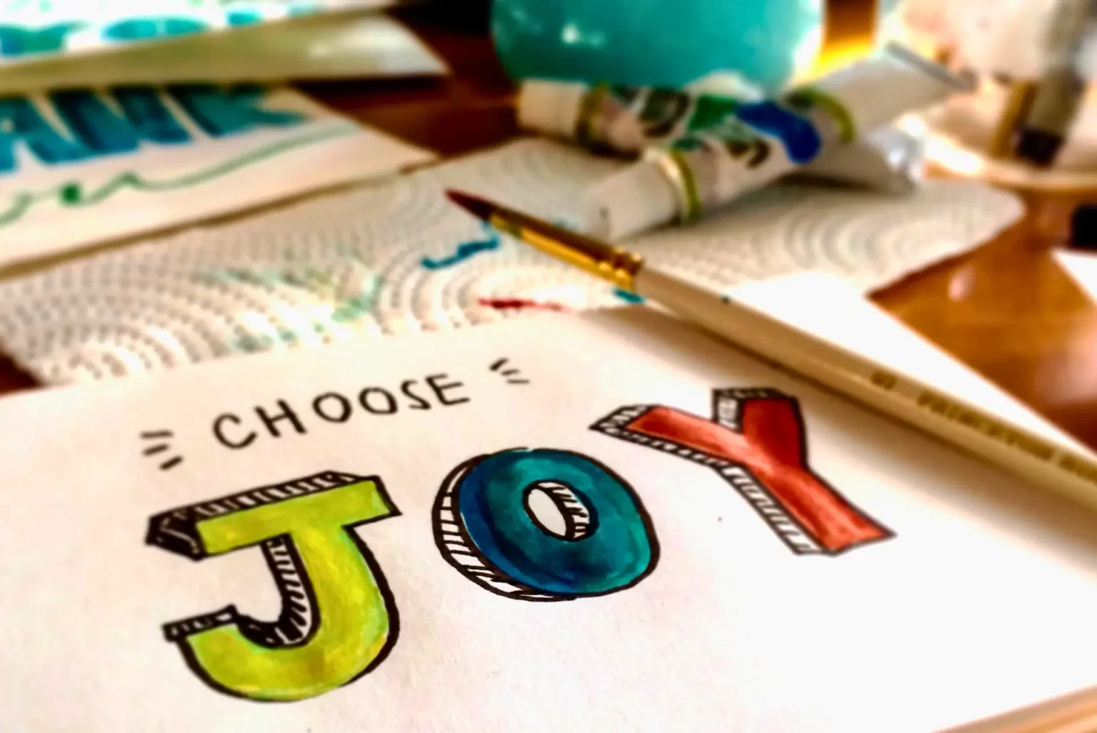 Colorful painting displaying the word "Joy" to illustrate the Romanian word bucurie