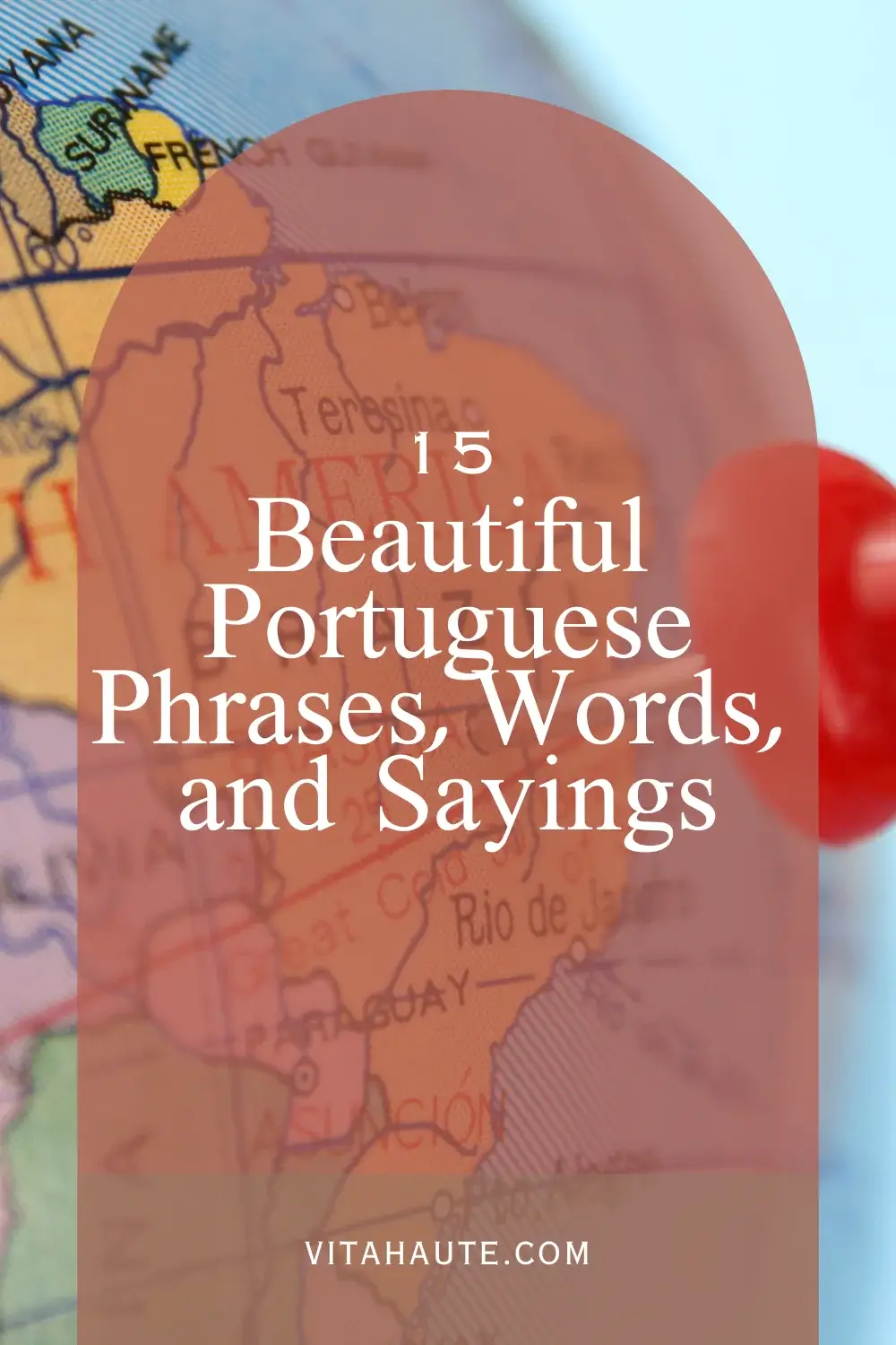 Handwritten Portuguese words in a notebook beside a dictionary